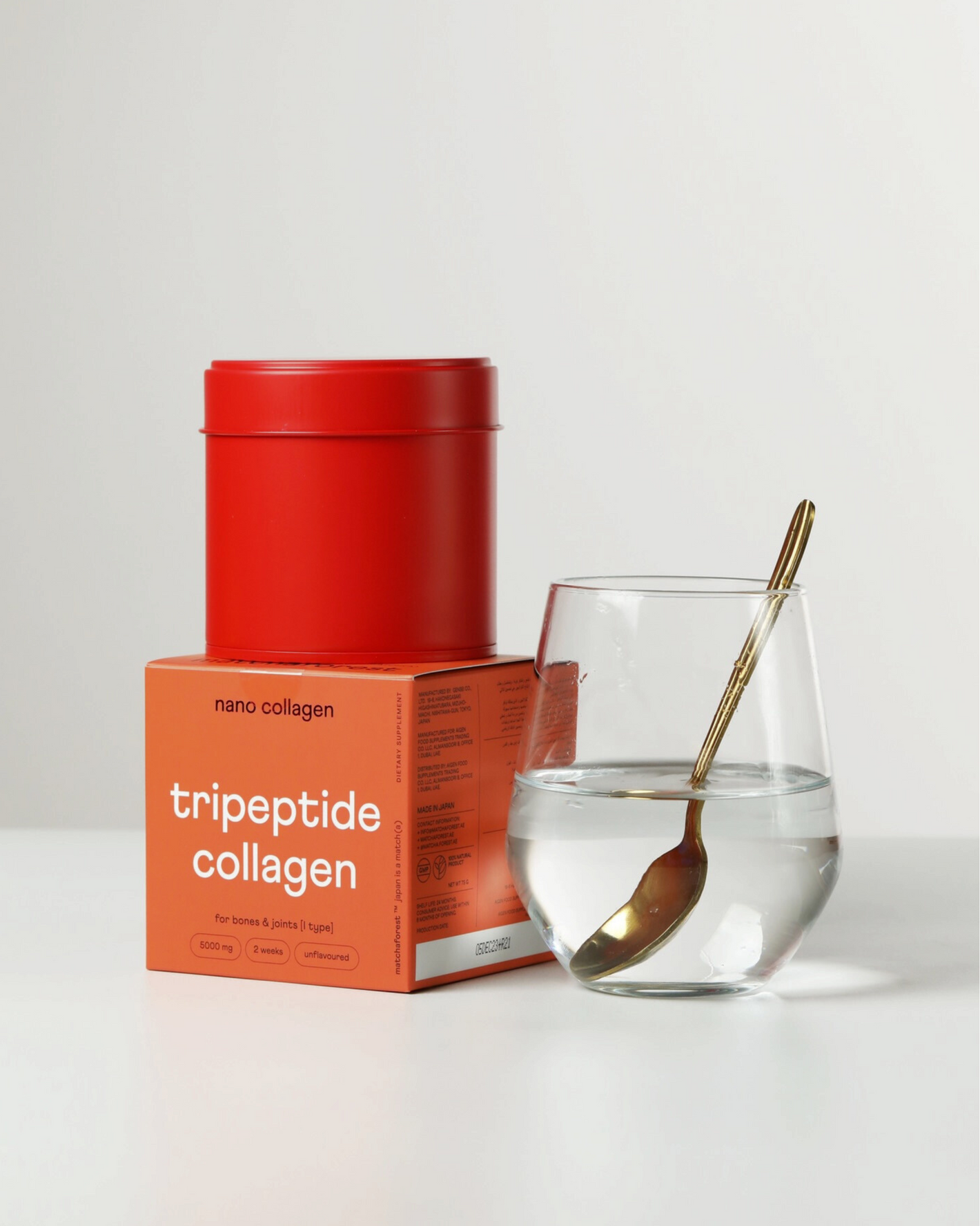 A packaging of marine tripeptide collagen for bones, muscles and joints next to a glass of clear water with collagen